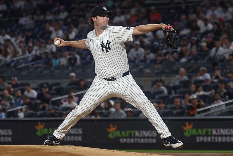 Sep 26, 2024; Bronx, New York, USA; New York Yankees starting pitcher Gerrit Cole (45) delivers a pitch during the first inning against the Baltimore Orioles at Yankee Stadium. Mandatory Credit: Vincent Carchietta-Imagn Images