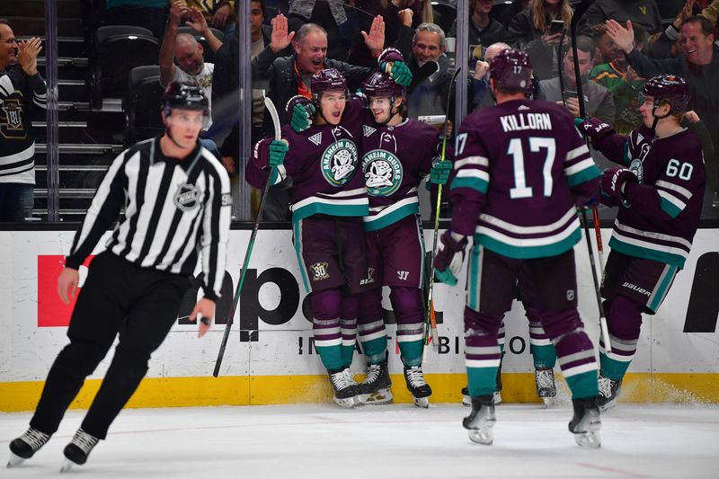 Dec 27, 2023; Anaheim, California, USA; Anaheim Ducks right wing Troy Terry (19) celebrates his goal scored against the Vegas Golden Knights with center Trevor Zegras (11) during the first period at Honda Center. Zegras provided an assist on the goal.  Mandatory Credit: Gary A. Vasquez-USA TODAY Sports