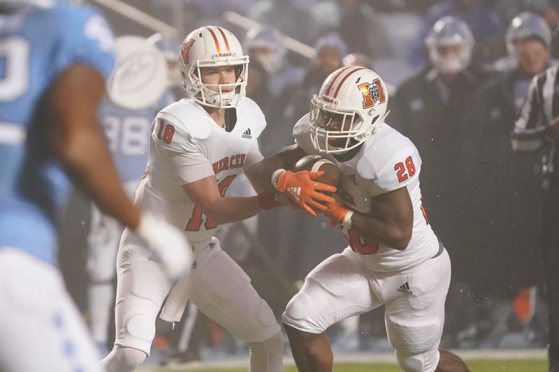 Nov 23, 2019; Chapel Hill, NC, USA;  Mercer Bears quarterback Harrison Frost (18) hands off the ball to running back Brandon Marshall (28) against the North Carolina Tar Heels at Kenan Memorial Stadium. The North Carolina Tar Heels defeated the Mercer Bears 56-7. Mandatory Credit: James Guillory-USA TODAY Sports