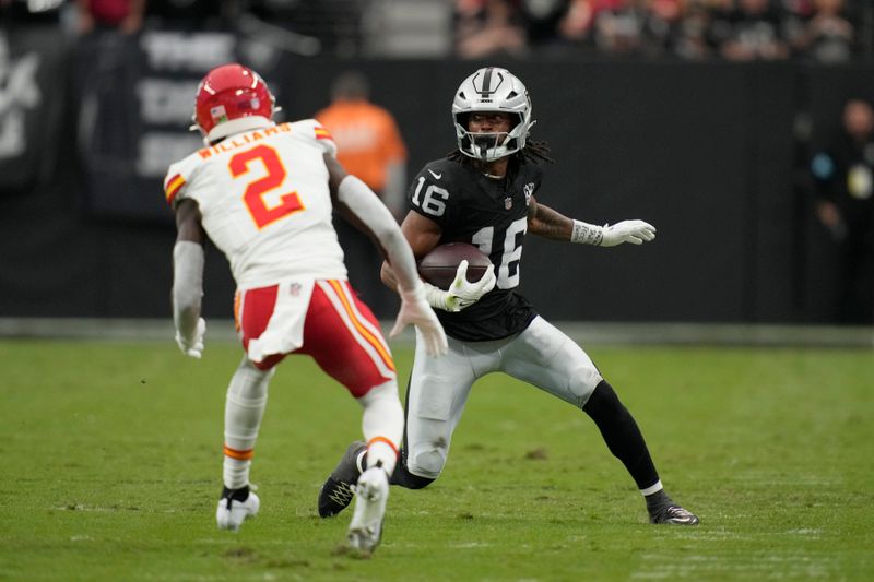 Las Vegas Raiders wide receiver Jakobi Meyers (16) runs with the ball as Kansas City Chiefs cornerback Joshua Williams (2) defends during the first half of an NFL football game Sunday, Oct. 27, 2024, in Las Vegas. (AP Photo/John Locher)