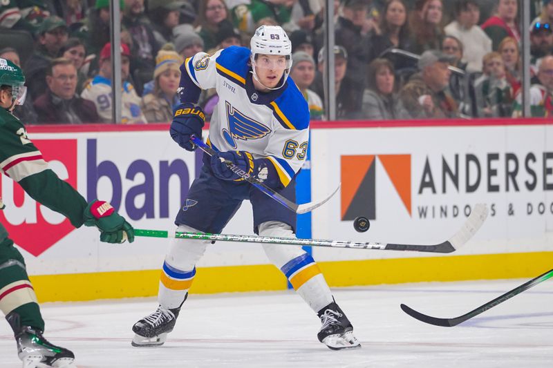 Nov 28, 2023; Saint Paul, Minnesota, USA; St. Louis Blues left wing Jake Neighbours (63) dumps the puck against the Minnesota Wild in the first period at Xcel Energy Center. Mandatory Credit: Brad Rempel-USA TODAY Sports