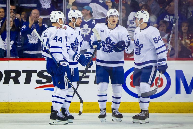 Jan 18, 2024; Calgary, Alberta, CAN; Toronto Maple Leafs center Auston Matthews (34) celebrates his goal with teammates against the Calgary Flames during the second period at Scotiabank Saddledome. Mandatory Credit: Sergei Belski-USA TODAY Sports