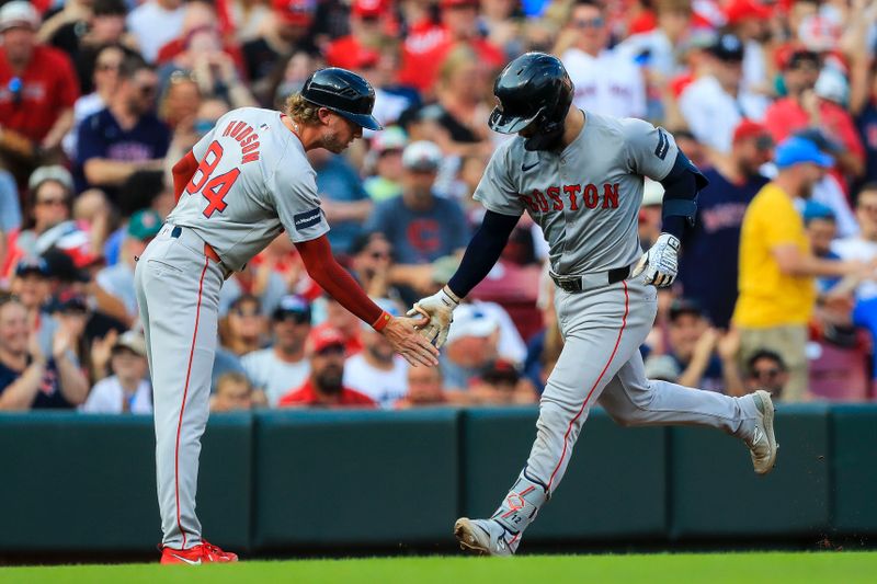 Jun 21, 2024; Cincinnati, Ohio, USA; Boston Red Sox catcher Connor Wong (12) high fives third base coach Kyle Hudson (84) after hitting a solo home run in the second inning against the Cincinnati Reds at Great American Ball Park. Mandatory Credit: Katie Stratman-USA TODAY Sports