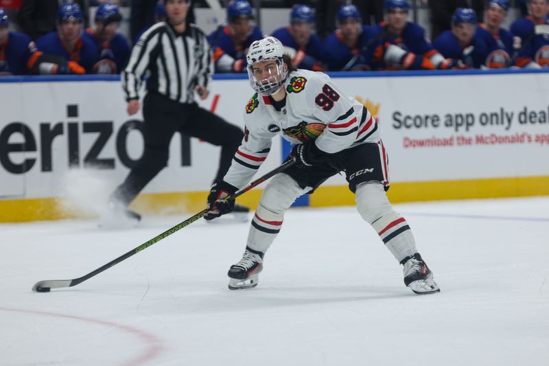 Apr 2, 2024; Elmont, New York, USA; Chicago Blackhawks center Connor Bedard (98) take a shot against the New York Islanders during the first period at UBS Arena. Mandatory Credit: Thomas Salus-USA TODAY Sports