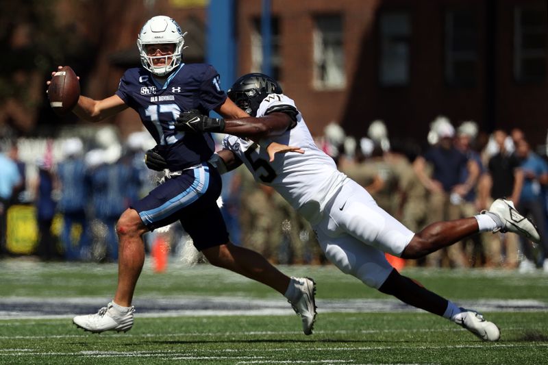 Sep 16, 2023; Norfolk, Virginia, USA; Old Dominion Monarchs quarterback Grant Wilson (13) is sacked by Wake Forest Demon Deacons defensive lineman Kendron Wayman (5) during the second quarter at Kornblau Field at S.B. Ballard Stadium. Mandatory Credit: Peter Casey-USA TODAY Sports