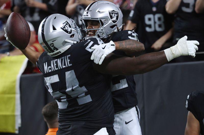 Las Vegas Raiders wide receiver Tyreik McAllister (32) celebrates scoring a touchdown against the San Francisco 49ers with offensive tackle Jalen McKenzie (54) during the second half of an NFL preseason football game, Friday, Aug. 23, 2024, in Las Vegas. (AP Photo/Ian Maule)