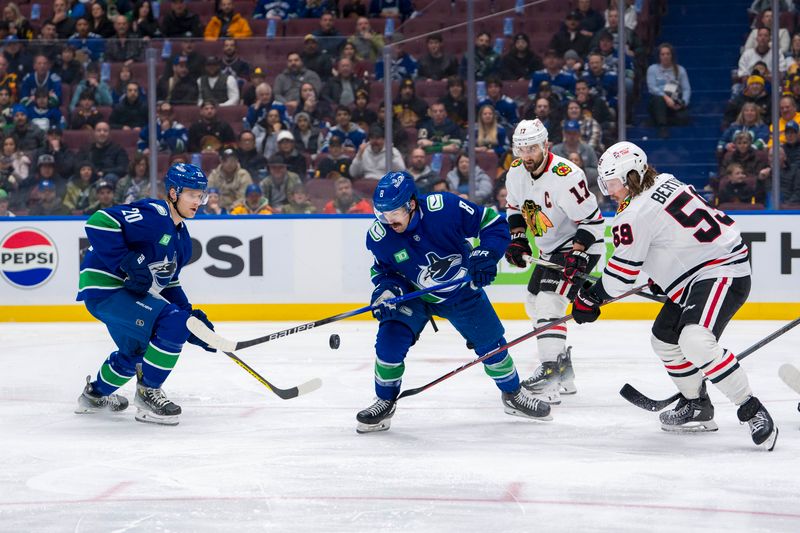 Nov 16, 2024; Vancouver, British Columbia, CAN; Vancouver Canucks forward Danton Heinen (20) and Chicago Blackhawks forward Nick Foligno (17) watch as Chicago forward Tyler Bertuzzi (59) and Vancouver forward Conor Garland (8) battle for the loose puck during the first period at Rogers Arena. Mandatory Credit: Bob Frid-Imagn Images