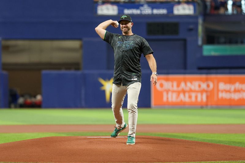 Jul 13, 2024; St. Petersburg, Florida, USA; former Tampa Bay Rays third baseman Evan Longoria throws out the first pitch before a game against the Cleveland Guardians at Tropicana Field. Mandatory Credit: Nathan Ray Seebeck-USA TODAY Sports