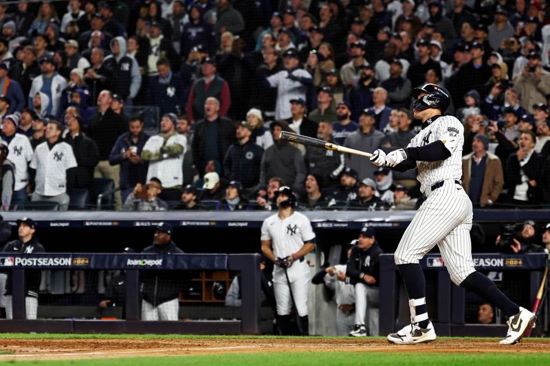 Oct 15, 2024; Bronx, New York, USA; New York Yankees outfielder Aaron Judge (99) hits a two run home run during the seventh inning against the Cleveland Guardians in game two of the ALCS for the 2024 MLB Playoffs at Yankee Stadium. Mandatory Credit: Vincent Carchietta-Imagn Images