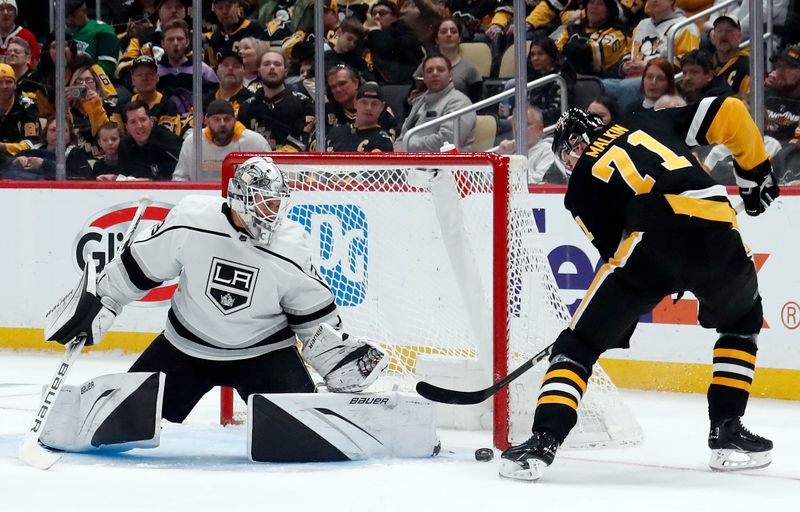 Feb 18, 2024; Pittsburgh, Pennsylvania, USA;  Los Angeles Kings goaltender Cam Talbot (39) makes a save against Pittsburgh Penguins center Evgeni Malkin (71) during the first period at PPG Paints Arena. Mandatory Credit: Charles LeClaire-USA TODAY Sports