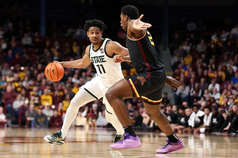 Feb 6, 2024; Minneapolis, Minnesota, USA; Michigan State Spartans guard A.J. Hoggard (11) works around Minnesota Golden Gophers forward Pharrel Payne (21) during the second half at Williams Arena. Mandatory Credit: Matt Krohn-USA TODAY Sports