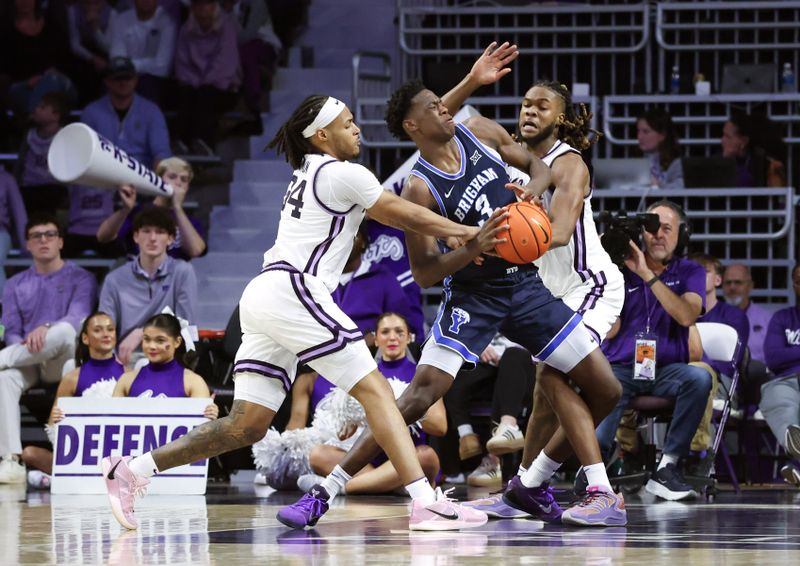 Jan 3, 2026; Manhattan, Kansas, USA; Brigham Young Cougars forward AJ Dybantsa (3) is guarded by Kansas State Wildcats guard Nate Johnson (34) and forward Khamari McGriff (21) during the second half at Bramlage Coliseum. Mandatory Credit: Scott Sewell-Imagn Images