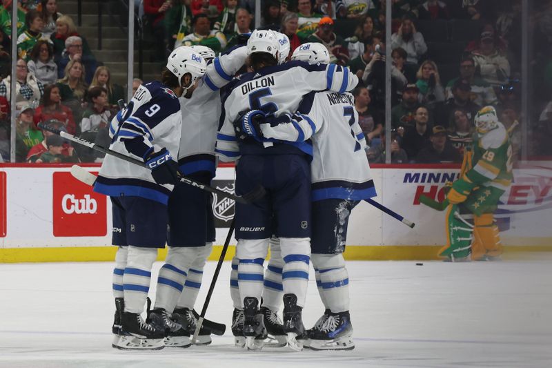 Apr 6, 2024; Saint Paul, Minnesota, USA; Winnipeg Jets defenseman Brenden Dillon (5) celebrates with teammates after scoring a goal against the Minnesota Wild at Xcel Energy Center. Mandatory Credit: Bruce Fedyck-USA TODAY Sports