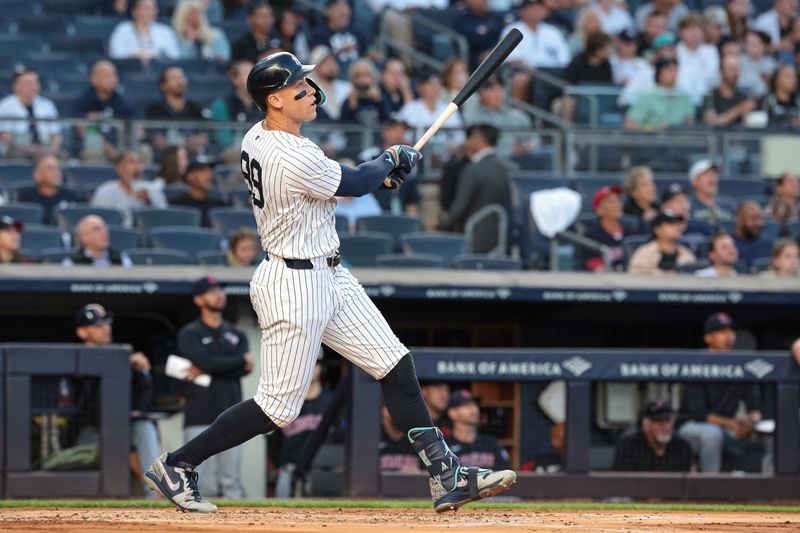 Aug 20, 2024; Bronx, New York, USA; New York Yankees center fielder Aaron Judge (99) hits a solo home run during the first inning against the Cleveland Guardians at Yankee Stadium. Mandatory Credit: Vincent Carchietta-USA TODAY Sports