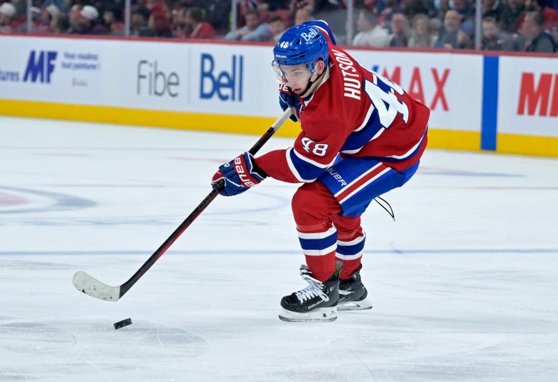 Oct 26, 2024; Montreal, Quebec, CAN; Montreal Canadiens defenseman Lane Hutson (48) plays the puck against the St.Louis Blues during the third period at the Bell Centre. Mandatory Credit: Eric Bolte-Imagn Images