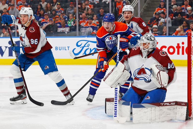 Mar 16, 2024; Edmonton, Alberta, CAN; Edmonton Oilers forward Zach Hyman (18) battles for position with Colorado Avalanche defensemen Cale Makar (8) in front of goaltender Alexander Georgiev (40) during the third period at Rogers Place. Mandatory Credit: Perry Nelson-USA TODAY Sports