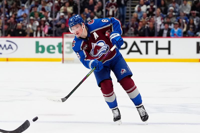 Apr 8, 2025; Denver, Colorado, USA; Colorado Avalanche defenseman Cale Makar (8) passes the puck in the second period against the Vegas Golden Knights at Ball Arena. Mandatory Credit: Ron Chenoy-Imagn Images