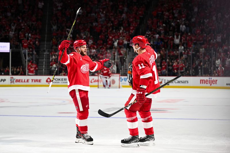 Oct 10, 2024; Detroit, Michigan, USA; Detroit Red Wings right wing Vladimir Tarasenko (11) celebrates his goal with right wing Alex DeBrincat (93) during the second period against the Pittsburgh Penguins at Little Caesars Arena. Mandatory Credit: Tim Fuller-Imagn Images