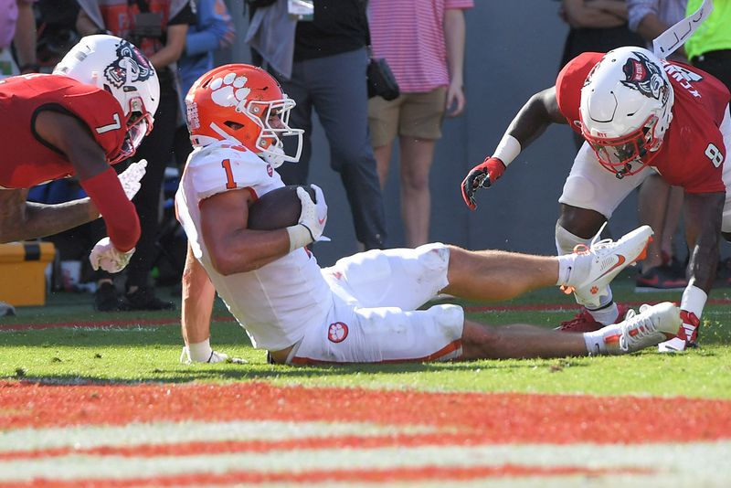 Oct 28, 2023; Raleigh, North Carolina, USA; Clemson Tigers running back Will Shipley (1) is hit by North Carolina State Wolfpack cornerback Shyheim Battle (7) near the goal line during the second quarter at Carter-Finley Stadium. Mandatory Credit: Ken Ruinard-USA TODAY Sports