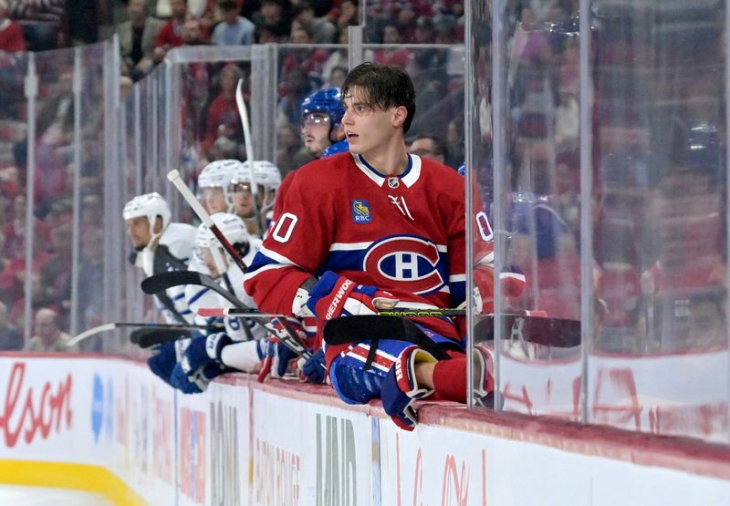 Oct 9, 2024; Montreal, Quebec, CAN; Montreal Canadiens forward Juraj Slafkovsky (20) returns to the bench after losing his helmet during the third period of the game against the Toronto Maple Leafs at the Bell Centre. Mandatory Credit: Eric Bolte-Imagn Images