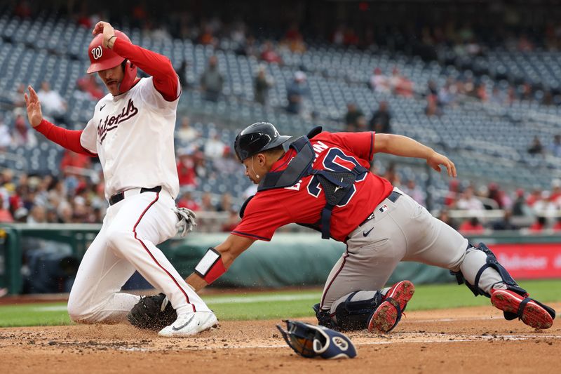 Sep 16, 2025; Washington, District of Columbia, USA; Washington Nationals third base Brady House (55) scores a run on a sacrifice fly by Nationals shortstop CJ Abrams (not pictured) ahead of a tag by Atlanta Braves catcher Drake Baldwin (30) during the second inning at Nationals Park. Mandatory Credit: Geoff Burke-Imagn Images