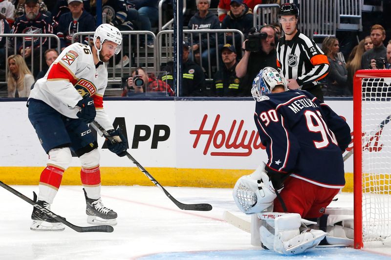 Oct 15, 2024; Columbus, Ohio, USA; Columbus Blue Jackets goalie Elvis Merzlikins (90) makes a save from the shot of Florida Panthers defenseman Uvis Balinskis (26) during the first period at Nationwide Arena. Mandatory Credit: Russell LaBounty-Imagn Images