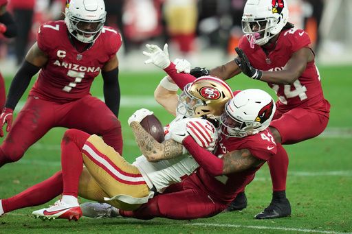 San Francisco 49ers wide receiver Ricky Pearsall (14) is tackled by Arizona Cardinals safety Dadrion Taylor-Demerson (42) during the second half of an NFL football game in Glendale, Ariz., Sunday, Jan. 5, 2025. (AP Photo/Ross D. Franklin)