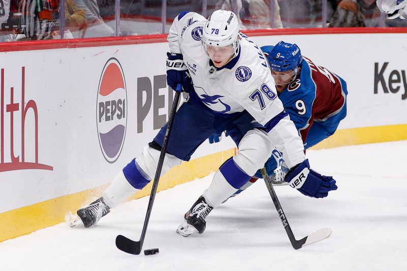 Oct 30, 2024; Denver, Colorado, USA; Tampa Bay Lightning defenseman Emil Lilleberg (78) controls the puck ahead of Colorado Avalanche center T.J. Tynan (9) in the second period at Ball Arena. Mandatory Credit: Isaiah J. Downing-Imagn Images