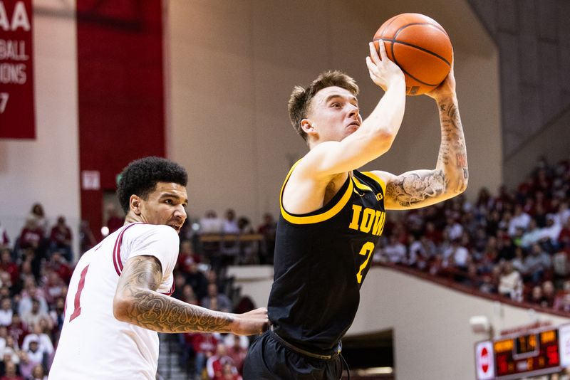 Jan 30, 2024; Bloomington, Indiana, USA; Iowa Hawkeyes guard Brock Harding (2) shoots the ball while Indiana Hoosiers center Kel'el Ware (1) defends in the second half at Simon Skjodt Assembly Hall. Mandatory Credit: Trevor Ruszkowski-USA TODAY Sports