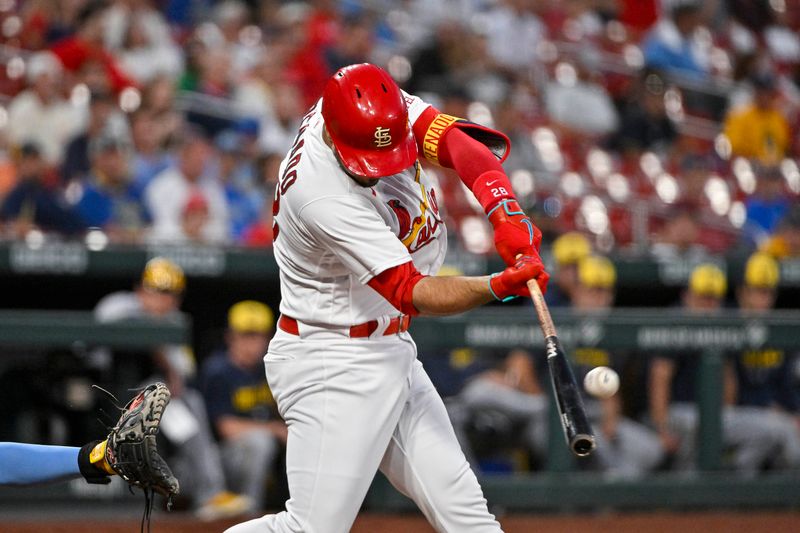 Sep 19, 2023; St. Louis, Missouri, USA;  St. Louis Cardinals third baseman Nolan Arenado (28) hits one run sacrifice fly against the Milwaukee Brewers during the first inning at Busch Stadium. Mandatory Credit: Jeff Curry-USA TODAY Sports