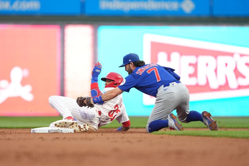 Jun 9, 2025; Philadelphia, Pennsylvania, USA; Chicago Cubs infielder Dansby Swanson (7) tags Philadelphia Phillies infielder Edmundo Sosa (33) out in the second inning at Citizens Bank Park. Mandatory Credit: Kyle Ross-Imagn Images
