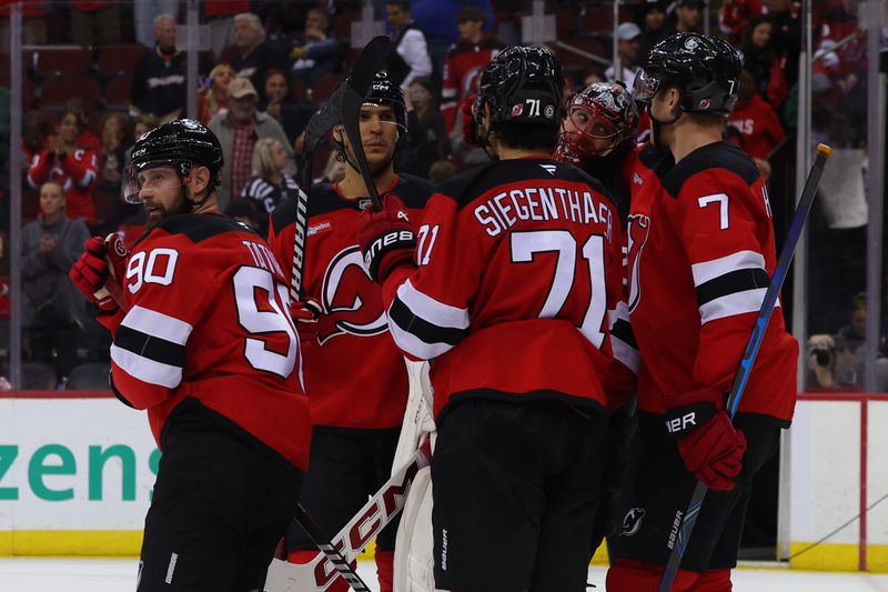 Oct 27, 2024; Newark, New Jersey, USA; The New Jersey Devils celebrate their win over the against the Anaheim Ducks at Prudential Center. Mandatory Credit: Ed Mulholland-Imagn Images