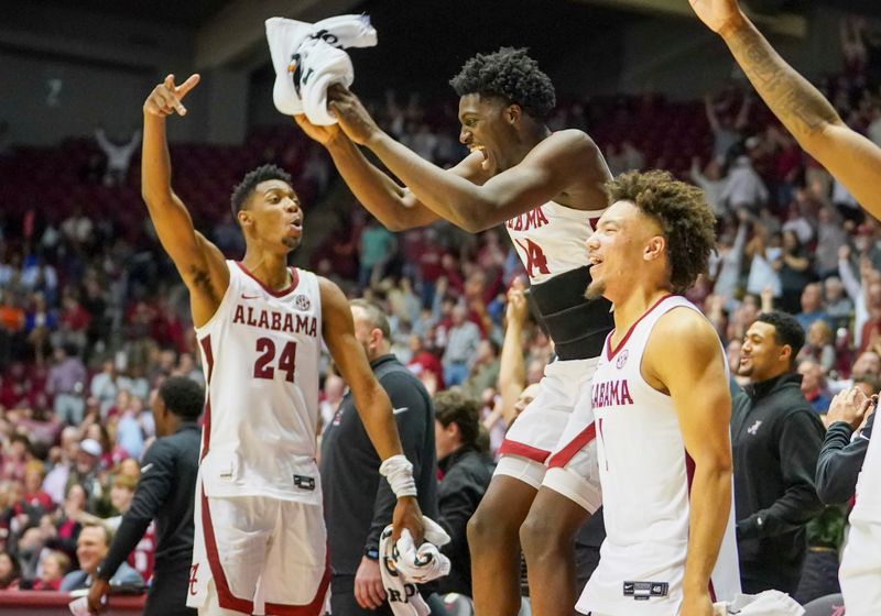 Feb 8, 2023; Tuscaloosa, Alabama, USA; Alabama Crimson Tide forward Brandon Miller (24) center Charles Bediako (14) and guard Mark Sears (1) celebrate on the bench after their teammate scored against the Florida Gators during the second half at Coleman Coliseum. Mandatory Credit: Marvin Gentry-USA TODAY Sports