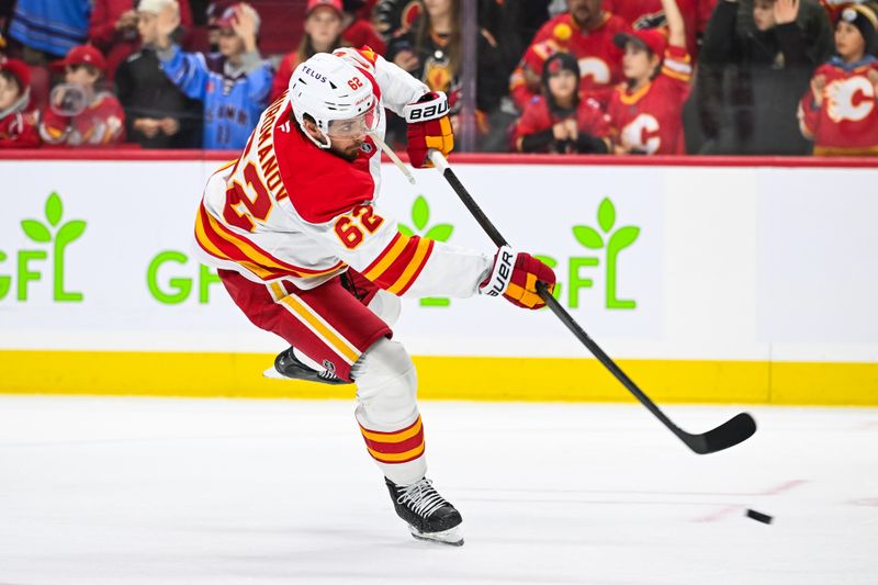 Nov 25, 2024; Ottawa, Ontario, CAN; Calgary Flames defenseman Daniil Miromanov (62) shoots a puck during warm-up before the game against the Ottawa Senators at Canadian Tire Centre. Mandatory Credit: David Kirouac-Imagn Images