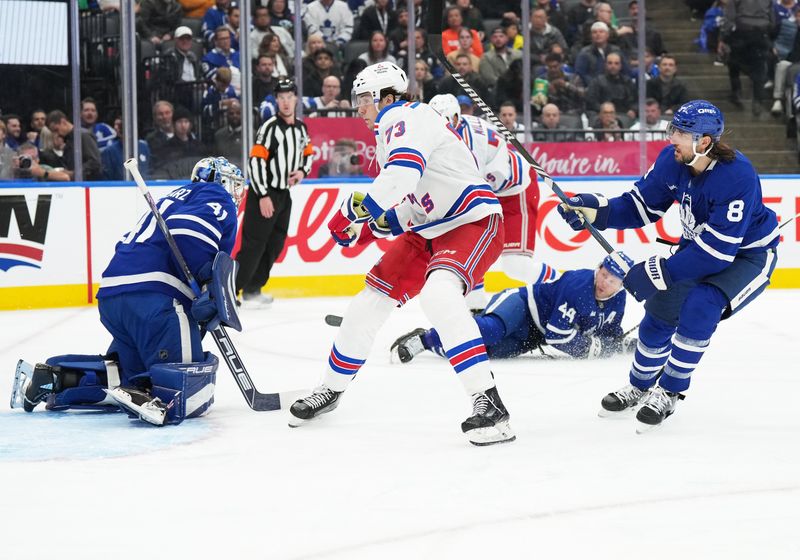 Oct 19, 2024; Toronto, Ontario, CAN; New York Rangers center Matt Rempe (73) battles in front of the net with Toronto Maple Leafs defenseman Chris Tanev (8) during the second period at Scotiabank Arena. Mandatory Credit: Nick Turchiaro-Imagn Images