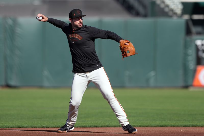 Aug 25, 2023; San Francisco, California, USA; San Francisco Giants shortstop Paul DeJong (18) warms up before the game against the Atlanta Braves at Oracle Park. Mandatory Credit: Darren Yamashita-USA TODAY Sports