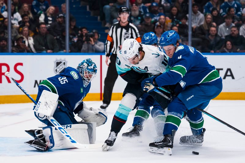 Jan 2, 2026; Vancouver, British Columbia, CAN; Vancouver Canucks goalie Thatcher Demko (35) watches as  defenseman Tom Willander (5) battles with Seattle Kraken forward Matty Beniers (10) in the first period at Rogers Arena. Mandatory Credit: Bob Frid-Imagn Images