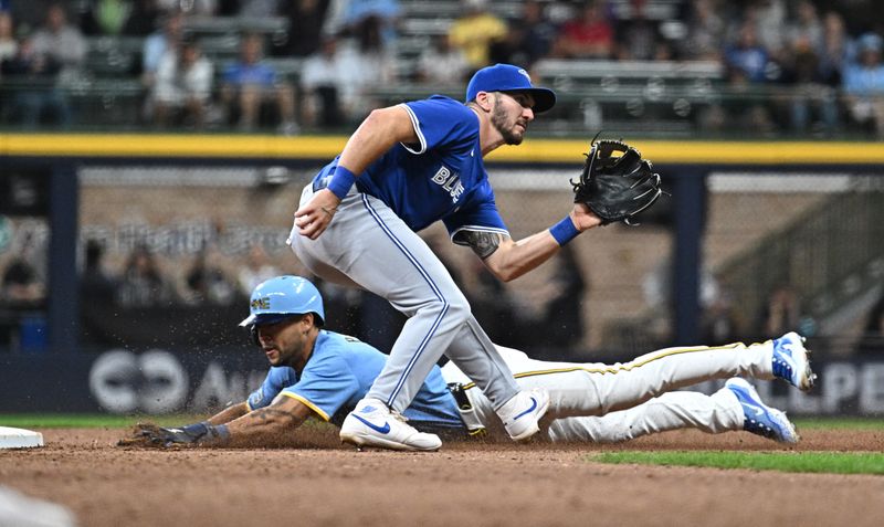 Jun 11, 2024; Milwaukee, Wisconsin, USA; Milwaukee Brewers outfielder Blake Perkins (16) steals second base ahead of the tag by Toronto Blue Jays second baseman Spencer Horwitz (48) in the sixth inning at American Family Field. Mandatory Credit: Michael McLoone-USA TODAY Sports