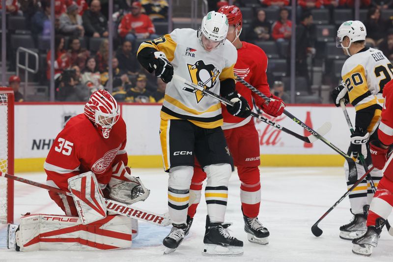 Oct 18, 2023; Detroit, Michigan, USA; Pittsburgh Penguins left wing Drew O   Connor (10) tries to score on Detroit Red Wings goaltender Ville Husso (35) in the first period at Little Caesars Arena. Mandatory Credit: Rick Osentoski-USA TODAY Sports