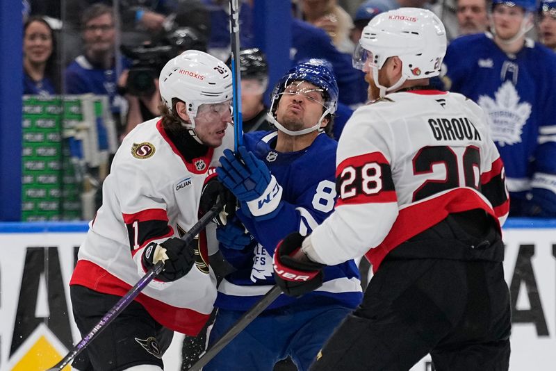 Apr 20, 2025; Toronto, Ontario, CAN; Ottawa Senators forward Adam Gaudette (81) and forward Claude Giroux (28) hit Toronto Maple Leafs forward Nicholas Robertson (89) during the third period of game one of the first round of the 2025 Stanley Cup Playoffs at Scotiabank Arena. Mandatory Credit: John E. Sokolowski-Imagn Images