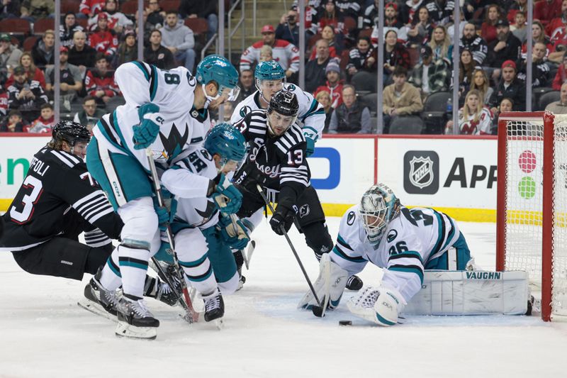 Dec 1, 2023; Newark, New Jersey, USA; San Jose Sharks goaltender Kaapo Kahkonen (36) covers the puck in front of New Jersey Devils center Nico Hischier (13) and right wing Tyler Toffoli (73) as center Tomas Hertl (48) and defenseman Mario Ferraro (38) defend during the first period at Prudential Center. Mandatory Credit: Vincent Carchietta-USA TODAY Sports