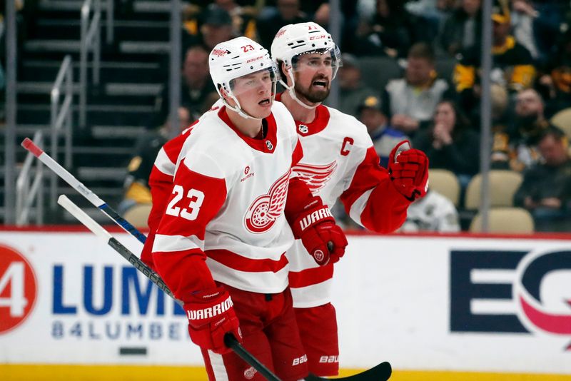 Apr 11, 2024; Pittsburgh, Pennsylvania, USA; Detroit Red Wings left wing Lucas Raymond (23) and center Dylan Larkin (71) celebrate after Raymond scored a goal to complete a hat-trick against the Pittsburgh Penguins during the third period at PPG Paints Arena. Pittsburgh won 6-5 in overtime. Mandatory Credit: Charles LeClaire-USA TODAY Sports