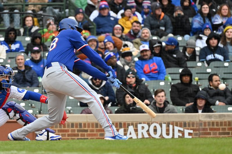 Apr 9, 2025; Chicago, Illinois, USA; Texas Rangers catcher Jonah Heim (28) hits a single during the sixth inning against the Chicago Cubs at Wrigley Field. Mandatory Credit: Patrick Gorski-Imagn Images