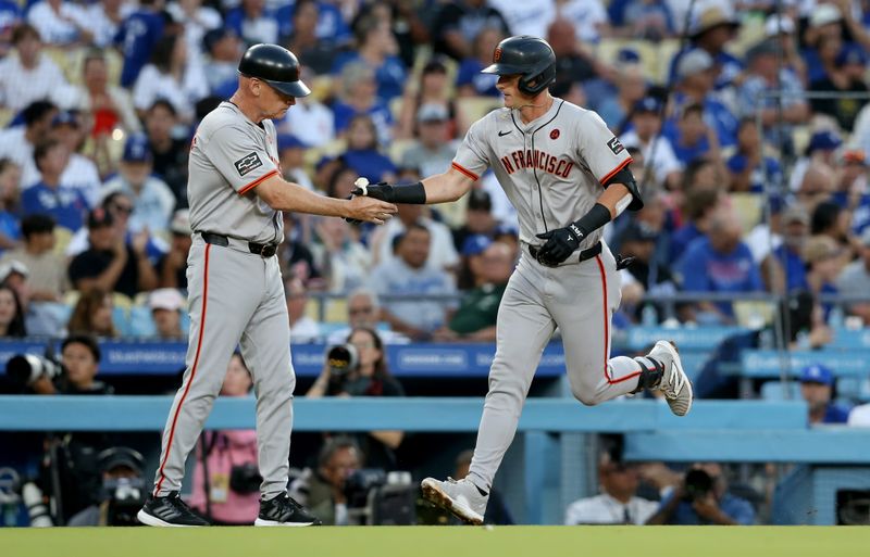 Jul 23, 2024; Los Angeles, California, USA; San Francisco Giants outfielder Tyler Fitzgerald (49) celebrates with third base coach Matt Williams (9) after hitting a home run during the second inning against the Los Angeles Dodgers at Dodger Stadium. Mandatory Credit: Jason Parkhurst-USA TODAY Sports