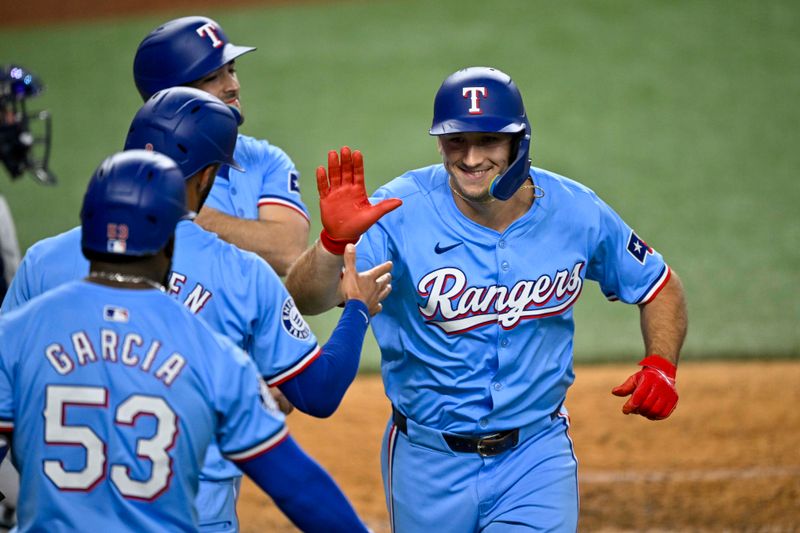 Sep 22, 2024; Arlington, Texas, USA; Texas Rangers left fielder Wyatt Langford (36) celebrates with shortstop Josh Smith (8) and second baseman Marcus Semien (2) and right fielder Adolis Garcia (53) after Langford hits a three run home run against the Seattle Mariners during the sixth inning at Globe Life Field. Mandatory Credit: Jerome Miron-Imagn Images