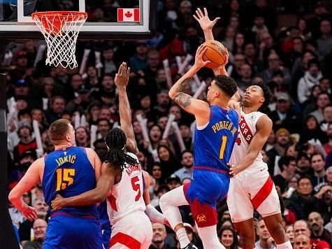 TORONTO, ON - DECEMBER 20: Michael Porter Jr. #1 of the Denver Nuggets goes to the basket against Scottie Barnes #4 of the Toronto Raptors as Precious Achiuwa #5 defends against Nikola Jokic #15 during the second half at Scotiabank Arena on December 20, 2023 in Toronto, Ontario, Canada. NOTE TO USER: User expressly acknowledges and agrees that, by downloading and/or using this Photograph, user is consenting to the terms and conditions of the Getty Images License Agreement. (Photo by Andrew Lahodynskyj/Getty Images)