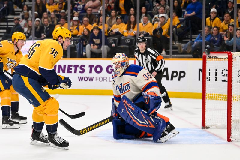 Jan 13, 2026; Nashville, Tennessee, USA;  Edmonton Oilers goaltender Tristan Jarry (35) blocks the shot of Nashville Predators left wing Cole Smith (36) during the first period at Bridgestone Arena. Mandatory Credit: Steve Roberts-Imagn Images