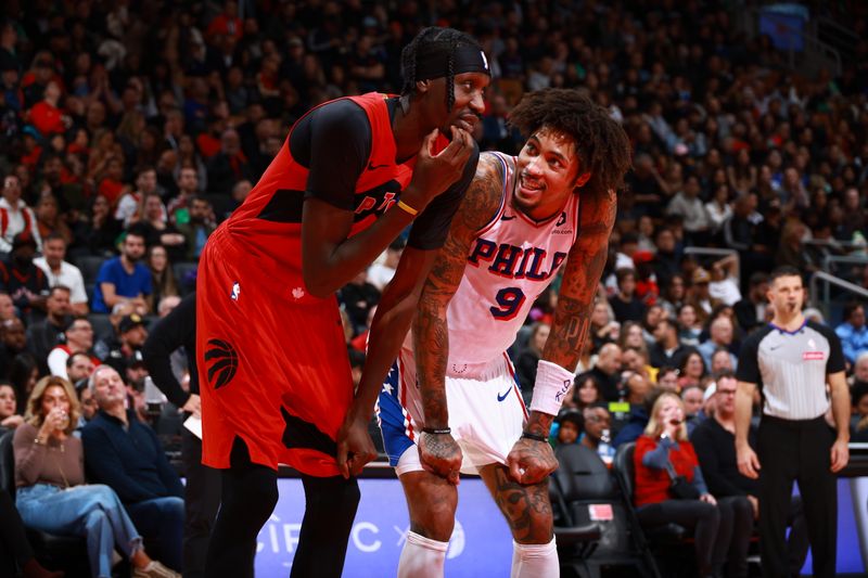 TORONTO, CANADA - OCTOBER 25: Chris Boucher #25 of the Toronto Raptors and Kelly Oubre Jr. #9 of the Philadelphia 76ers speak during the game on October 25, 2024 at the Scotiabank Arena in Toronto, Ontario, Canada.  NOTE TO USER: User expressly acknowledges and agrees that, by downloading and or using this Photograph, user is consenting to the terms and conditions of the Getty Images License Agreement.  Mandatory Copyright Notice: Copyright 2024 NBAE (Photo by Vaughn Ridley/NBAE via Getty Images)