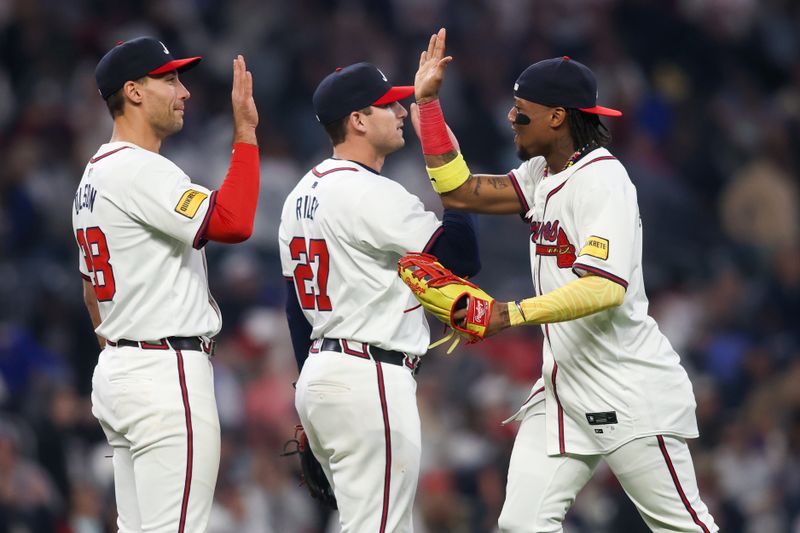Apr 6, 2024; Atlanta, Georgia, USA; Atlanta Braves first baseman Matt Olson (28) and third baseman Austin Riley (27) and right fielder Ronald Acuna Jr. (13) celebrate after a victory against the Arizona Diamondbacks at Truist Park. Mandatory Credit: Brett Davis-USA TODAY Sports