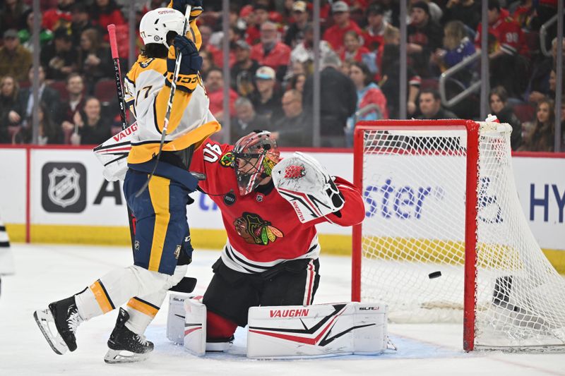 Apr 12, 2024; Chicago, Illinois, USA; Chicago Blackhawks goaltender Arvid Soderblom (40) is scored on during a power play while being screened by Nashville Predators forward Luke Evangelista (77) in the first period at United Center. Mandatory Credit: Jamie Sabau-USA TODAY Sports